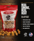 A 12 oz resealable bag of Chili Pepper Pistachios on a dark wood background with scattered pistachios in front. The packaging is red, white, and clear, showing the nuts inside.