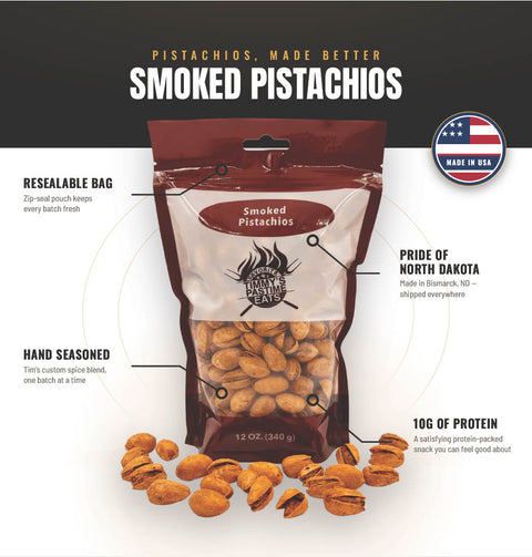 A 12 oz bag of smoked pistachios centered on a white and black marketing graphic with callout text and a 'Made in USA' badge. The package is dark red and clear, showing tan pistachios inside, with additional pistachios scattered around the bag.