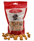 Red package of smoked chili pepper pistachios with pistachios scattered around on a white background